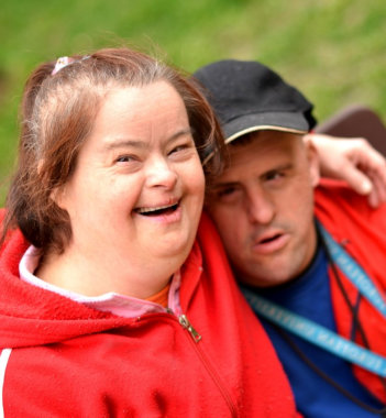 a couple of mentally disabled children laughing in front of the camera