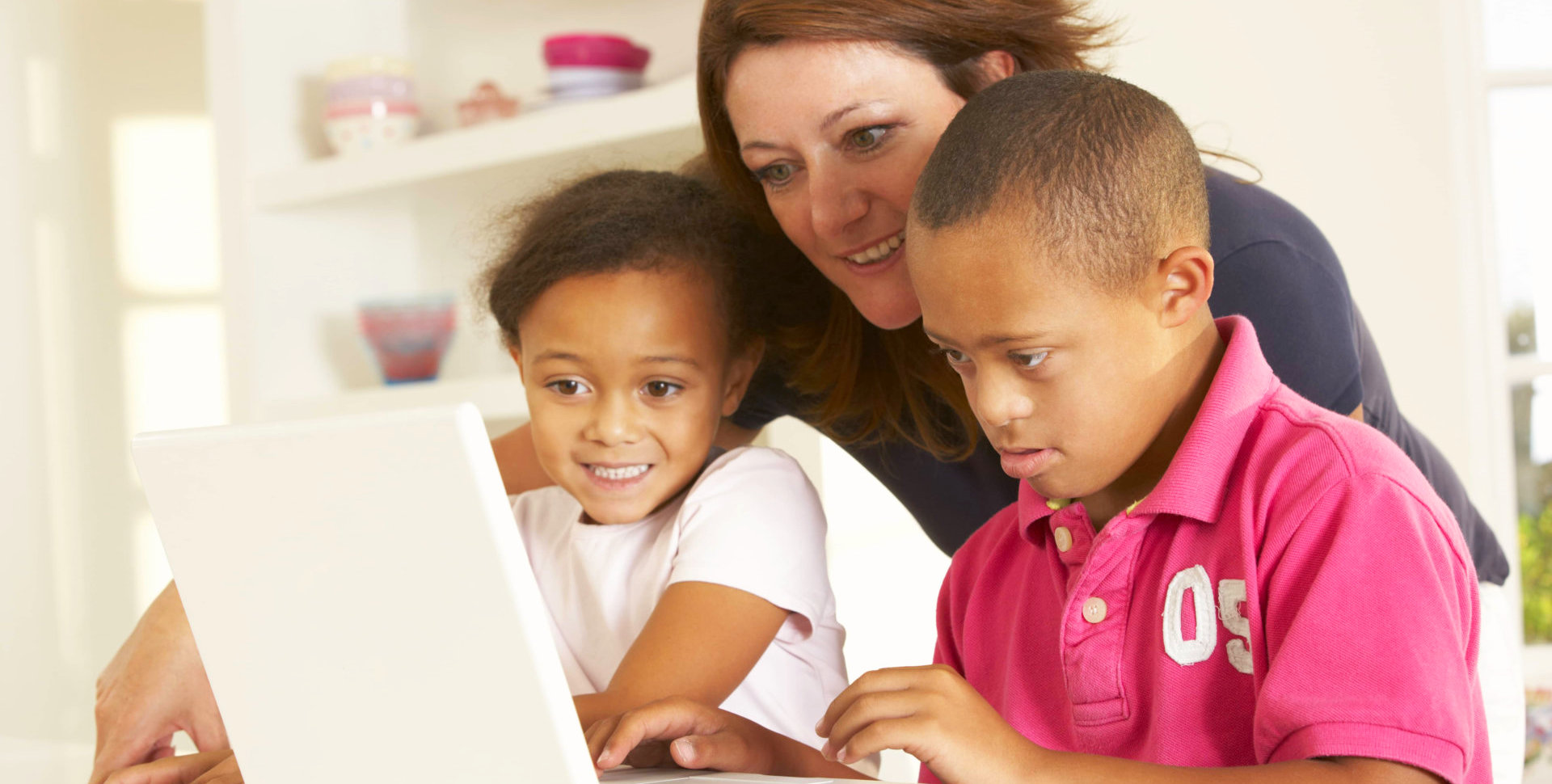 caregiver helping a couple of mentally disabled children